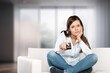 © BillionPhotos.com - Happy Young Woman with Remote Controller Watching TV