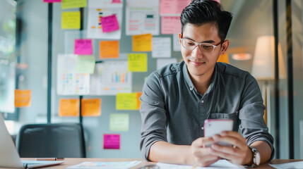 Asian designer working business creative in application software design on smartphone.