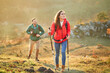 © tunedin - Couple walking on alpine meadow on a hiking trip in the mountains