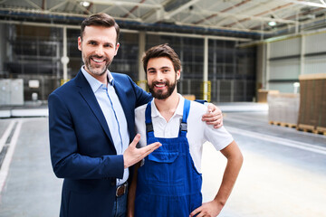 Canvas Print - Portrait of happy businessman and worker in a factory