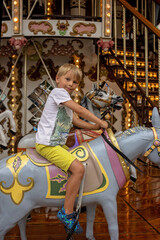 Poster - Children, boys, going on Merry Go Round, kids play on carousel in the summer