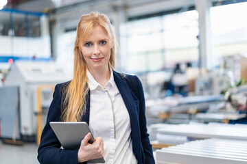 Canvas Print - Portrait of confident businesswoman with tablet in factory