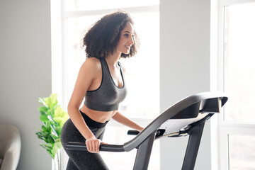 Sticker - Photo of lovely adorable cheerful active girl coach walk treadmill physical exercises in gym daylight indoors