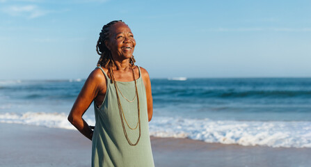 Wall Mural - Mature woman with braids enjoying a casual day at the seaside