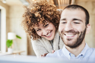 Poster - Happy man and woman sharing tablet in modern office