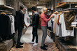 © tunedin - Three men in modern menswear shop with new collection
