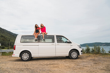 Poster - Friends traveling through Norwegian lapland with a camping van