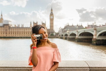 Wall Mural - UK, London, beautiful woman taking a picture near Westminster Bridge