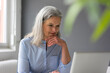© tunedin - Portrait of mature businesswoman using laptop in office