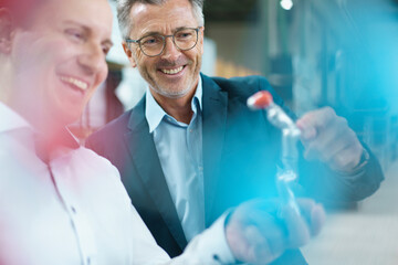 Sticker - Two happy businessmen holding product in a factory