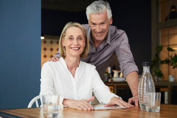 Portrait of smiling mature couple at home