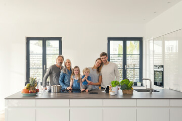 Wall Mural - Happy family with grandparents and children standing in the kitchen