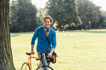 Sticker - Portrait of relaxed man with racing cycle in a park