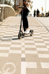 Poster - Man using E-Scooter and mobile phone in the city, partial view