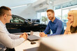© tunedin - Salesperson advising couple in car dealership