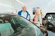 © tunedin - Couple looking at car in dealeship