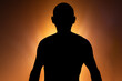 © Thales - Man in silhouette, standing still and shirtless, posing for a photo.