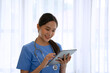 © Suney - Female health care worker  is using digital tablet.