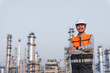 © BJ Day Stock - Happy handsome Asian man petrochemical engineer standing with arm crossed and smiling to camera. Petroleum oil refinery in industrial estate background. Engineers at industry manufacturing.