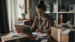 © VK Studio - Focused entrepreneur at work amidst home office chaos.