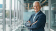 © VK Studio - Confident senior businessman smiling in a modern office environment.