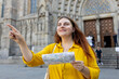 © mdyn - Young woman tourist with paper map standing in front of the famous saint Eulalia church in Barcelona. Concept of travel, tourism and vacation in city. Cathedral of Barcelona