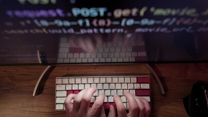 Hands of Professional Programmer is typing code. Top down wide shot