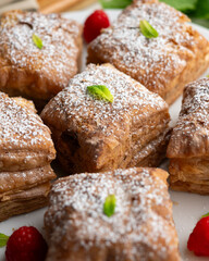 Wall Mural - Miguelitos are typical pastries from Spain made from puff pastry, filled with chocolate cream and sprinkled with sugar.