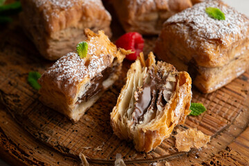 Wall Mural - Miguelitos are typical pastries from Spain made from puff pastry, filled with chocolate cream and sprinkled with sugar.