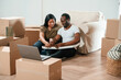 © standret - Tasty pizza, sitting and eating. African American couple are moving into new house
