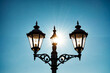 © Alex Vog - Antique stylish street lamp at blue sky background. Decorative retro vintage lantern on wrought iron lamp post for image design. Street art concept. Copy text space for advertising