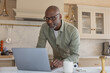 © ReeldealHD images - Senior man at home in his kitchen using a laptop for online banking
