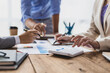 © Wasan - Financial consulting business meeting together to discuss financial chart analysis and brainstorm company budget planning.