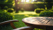 © PixMarket - Close-up of empty wooden table with chair in backyard with green lawn on dawn