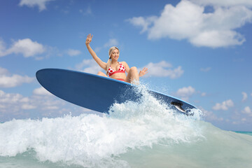 Sticker - Female surfer jumping with a surfboard