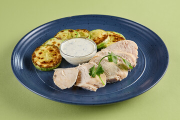 Wall Mural - Steamed Chicken Fillet with Zucchini and Herb Sauce on Blue Plate – Healthy Diet Menu