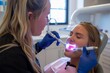 © spyrakot - Dental Hygienist Demonstrating Proper Use of Electric Toothbrush in Modern Clinic Setting for Oral Care