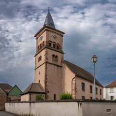 Canvas Print - Goxwiller, France - 06 29 2023: View of the church in church alley of Goxwiller.