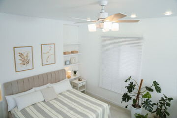 Canvas Print - Ceiling fan, bed and houseplants in stylish bedroom, above view