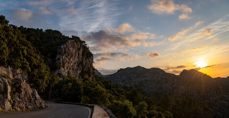 Panoramic view of the winding Sa Calobra road at sunset, tucked within Tramuntana mountain range, in the northwest of Majorca, Balearic Islands, Spain
