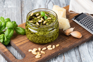 Wall Mural - Bowl of basil pesto on wooden table