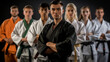 © Nataliia_Trushchenko - A group of people wearing black and white uniforms stand together. One man is wearing a green belt. Sensei in a black kimono and a black belt with students, all students in a white kimono