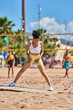 © JENOCHE - Young athletic latin woman on the beach doing sports