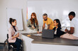 © Zamrznuti tonovi - Woman with disability discussing the business strategy with her diverse team