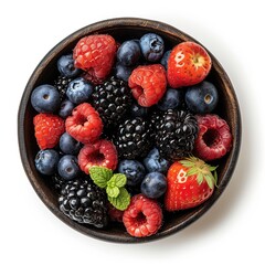 Wall Mural - A bowl of juicy and fresh mixed berries top view isolated on a white background