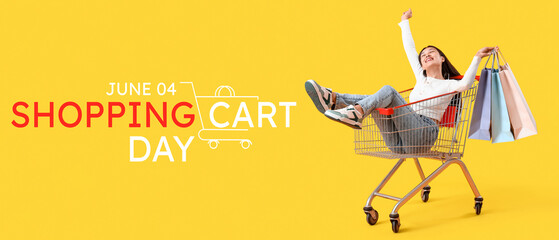 Wall Mural - Young Asian woman with bags in shopping cart on yellow background