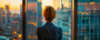 © Pui - Person looking out the window of a high-rise office building, visualizing future possibilities