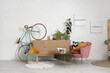 © Pixel-Shot - Light living room with pink armchair, pillows, chest of drawers and bicycle