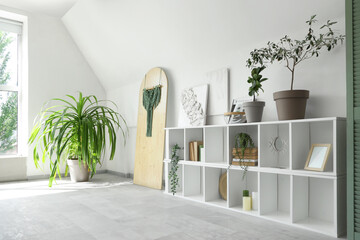 Sticker - Interior of light room with shelving unit, houseplants and pictures