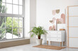 © Pixel-Shot - Stylish room with chest of drawers, houseplant and picture on white wall